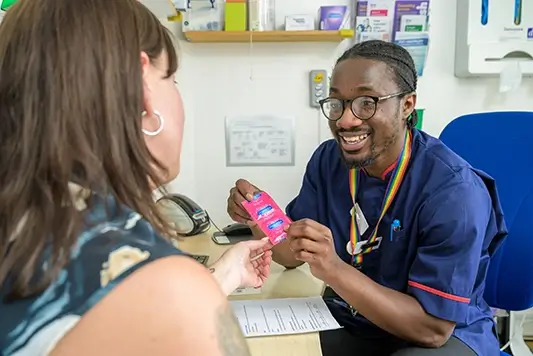 MSI UK nurse showing client external condoms.