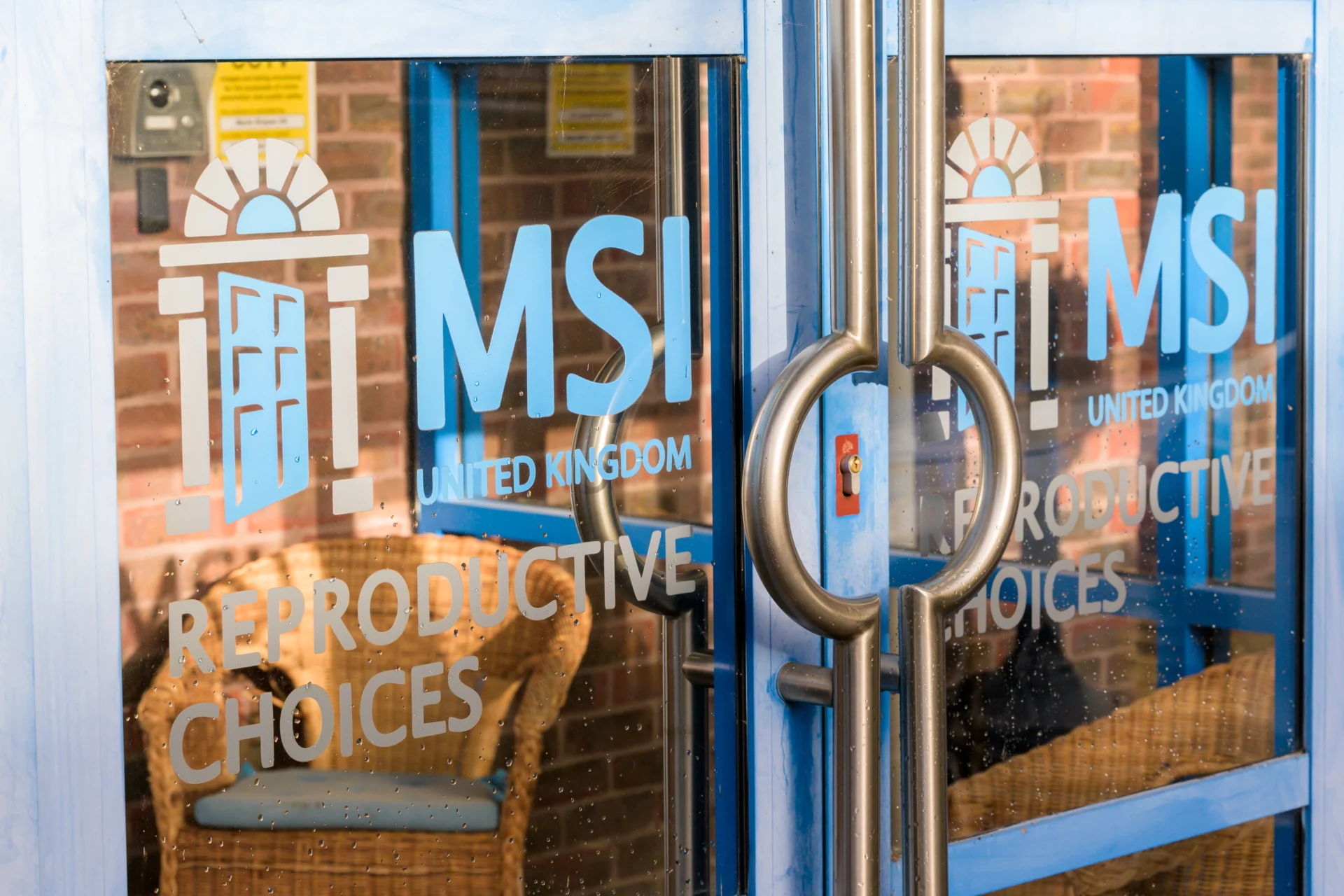 A close-up of the front doors of a clinic with the MSI logo on the glass.