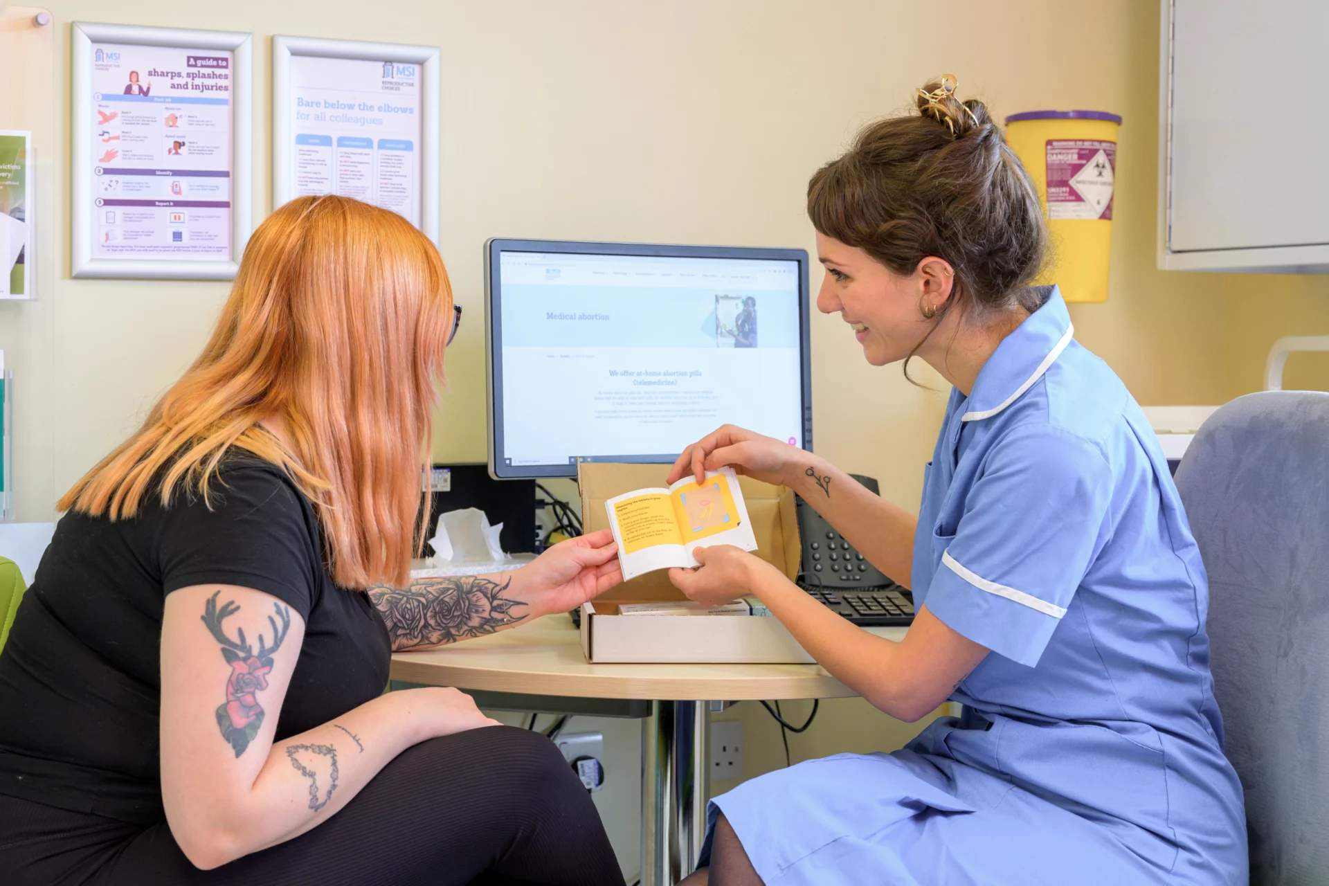 MSI UK nurse showing client a medical abortion leaflet.
