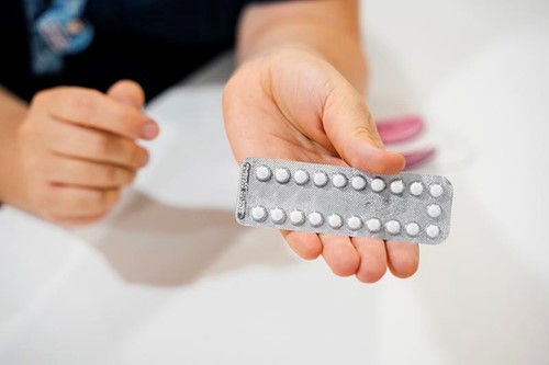 Contraceptive pill in MSI UK nurse hand.