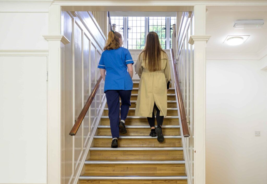Nurse walking with abortion client up the stairs