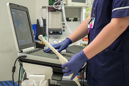 Nurse using scan machine