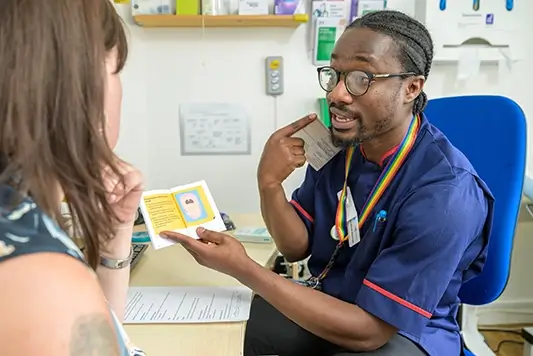Nurse showing client how to take the abortion pill