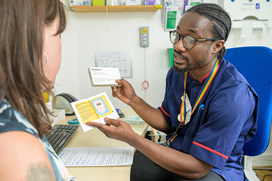 MSI UK nurse showing medical abortion leaflet.