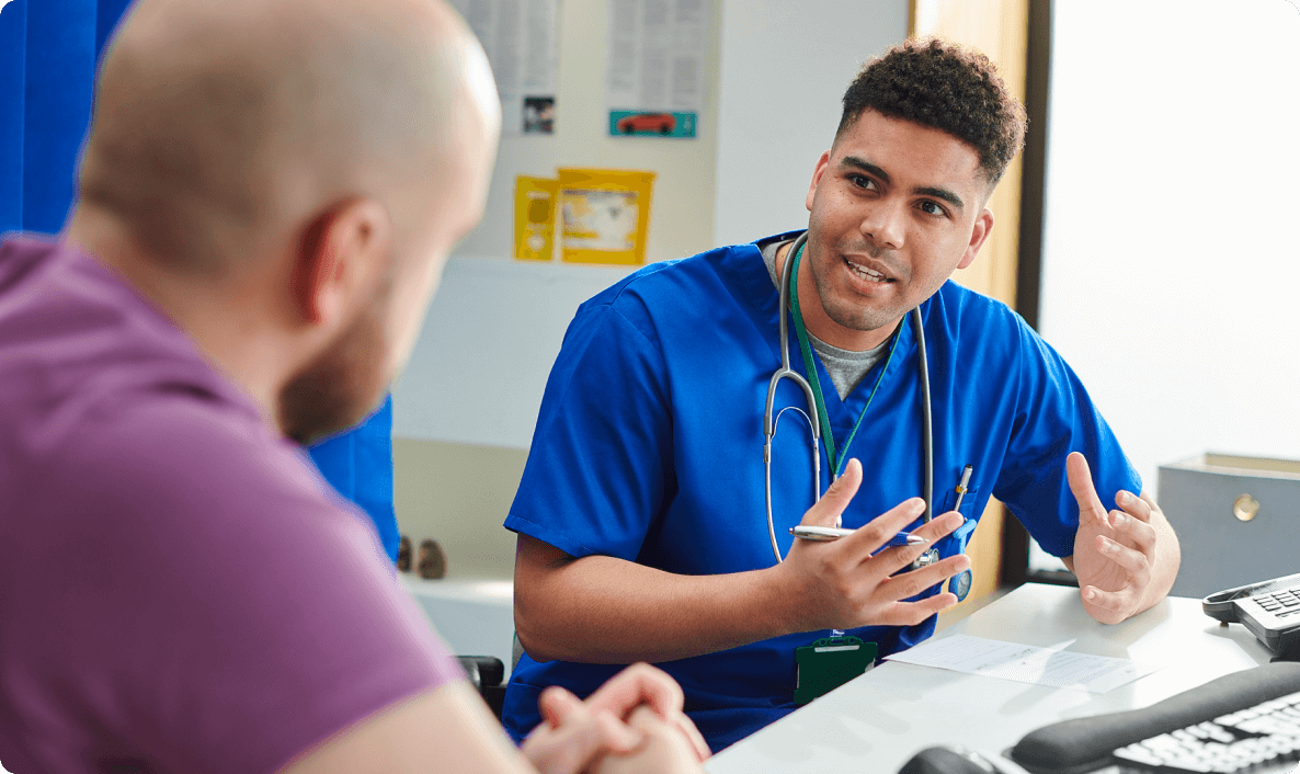 Man talks to doctor in clinic.