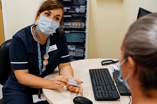 MSI UK nurse showing client contraceptive pill.