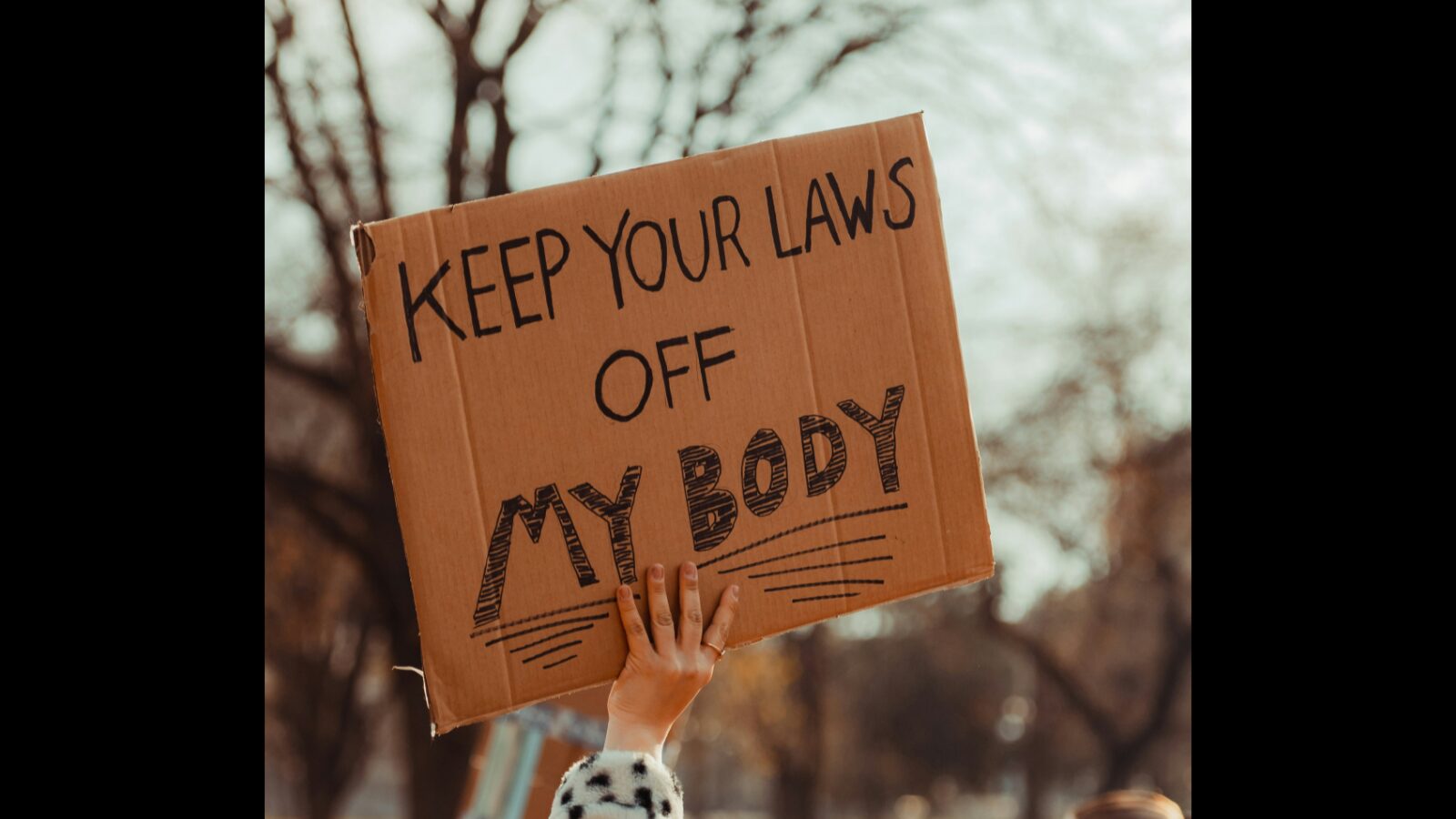 Sign with the text: keep your laws of my body.